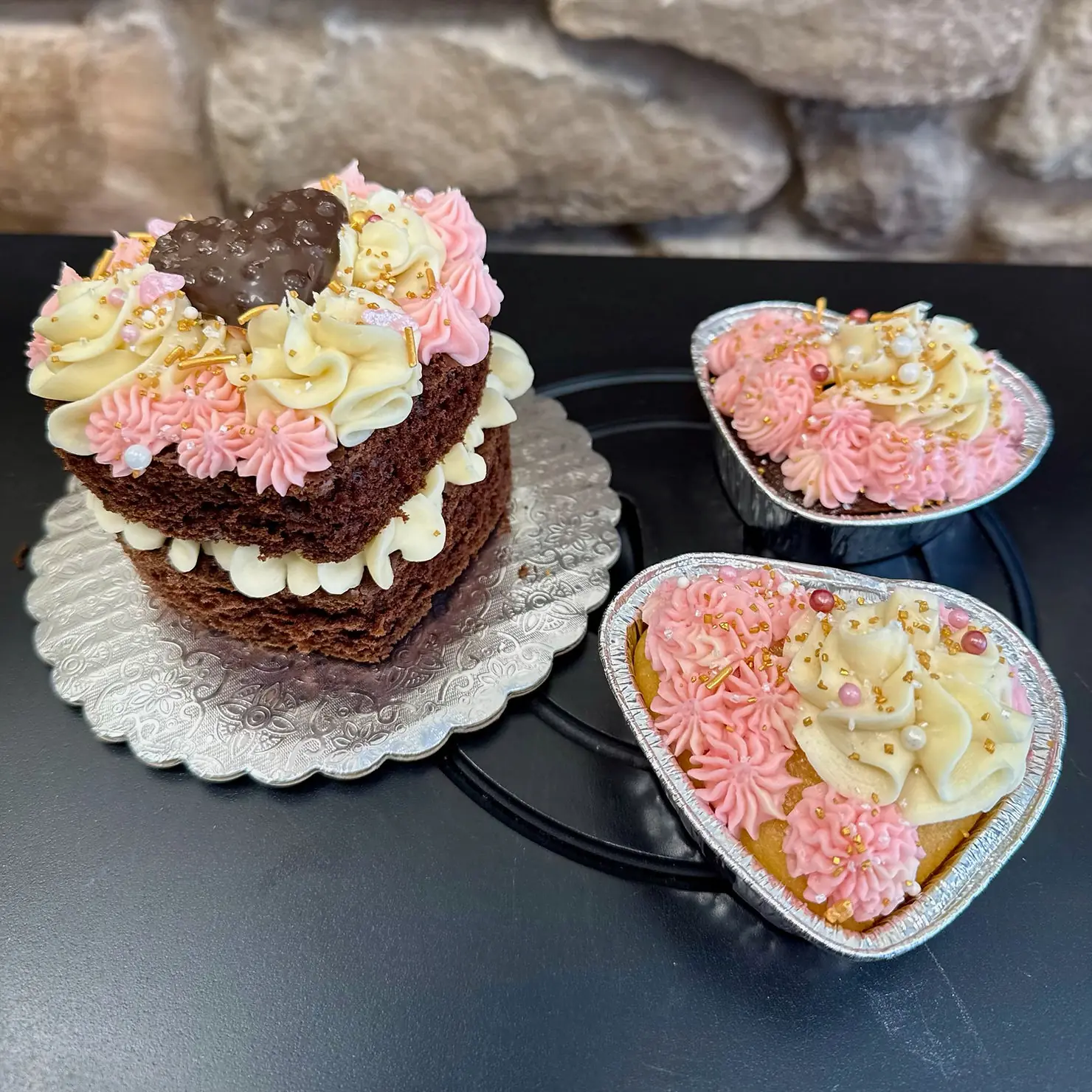 Close-up view of heart-shaped red velvet cupcakes with cream cheese frosting