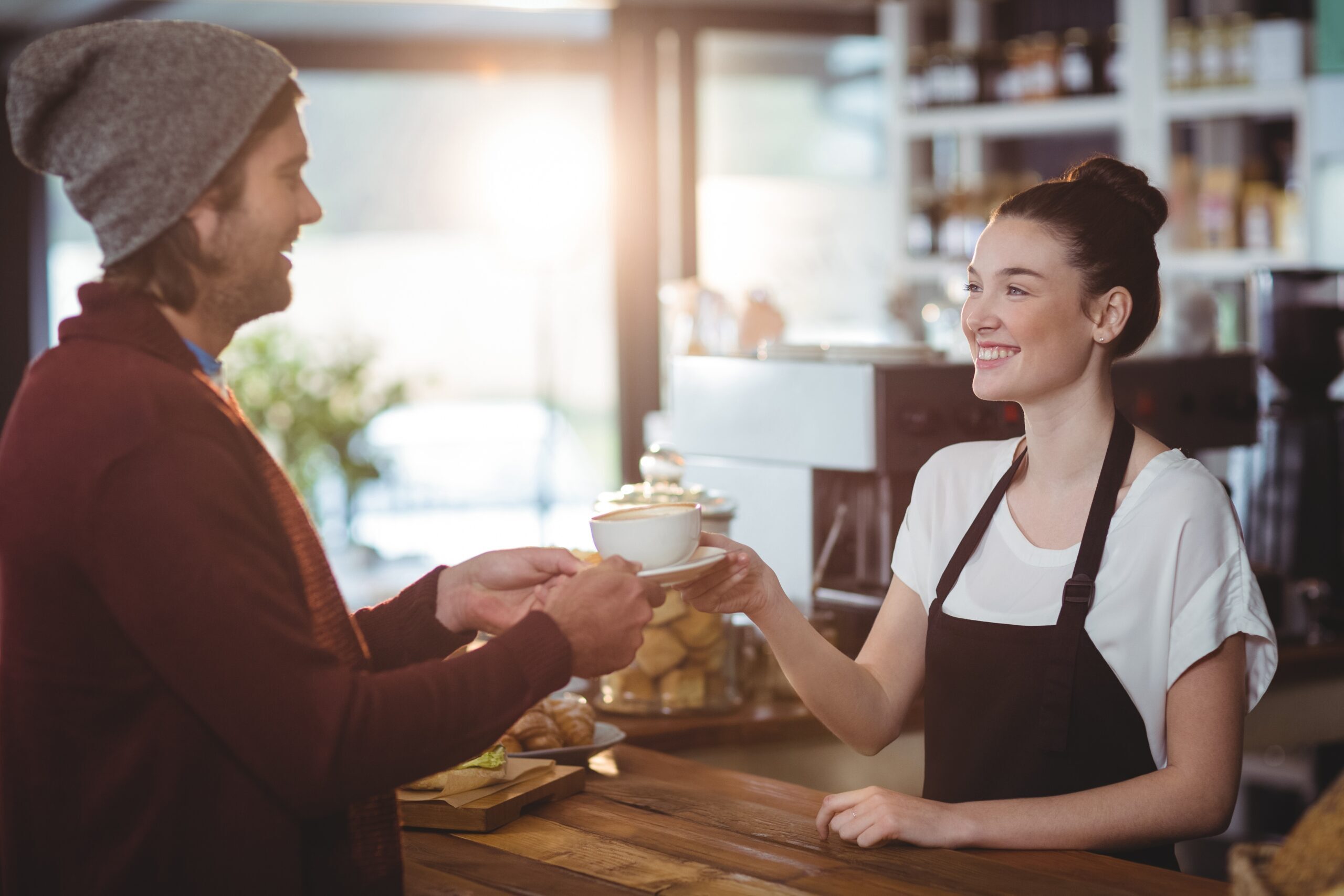 Waitress serving a cup of coffee to customer